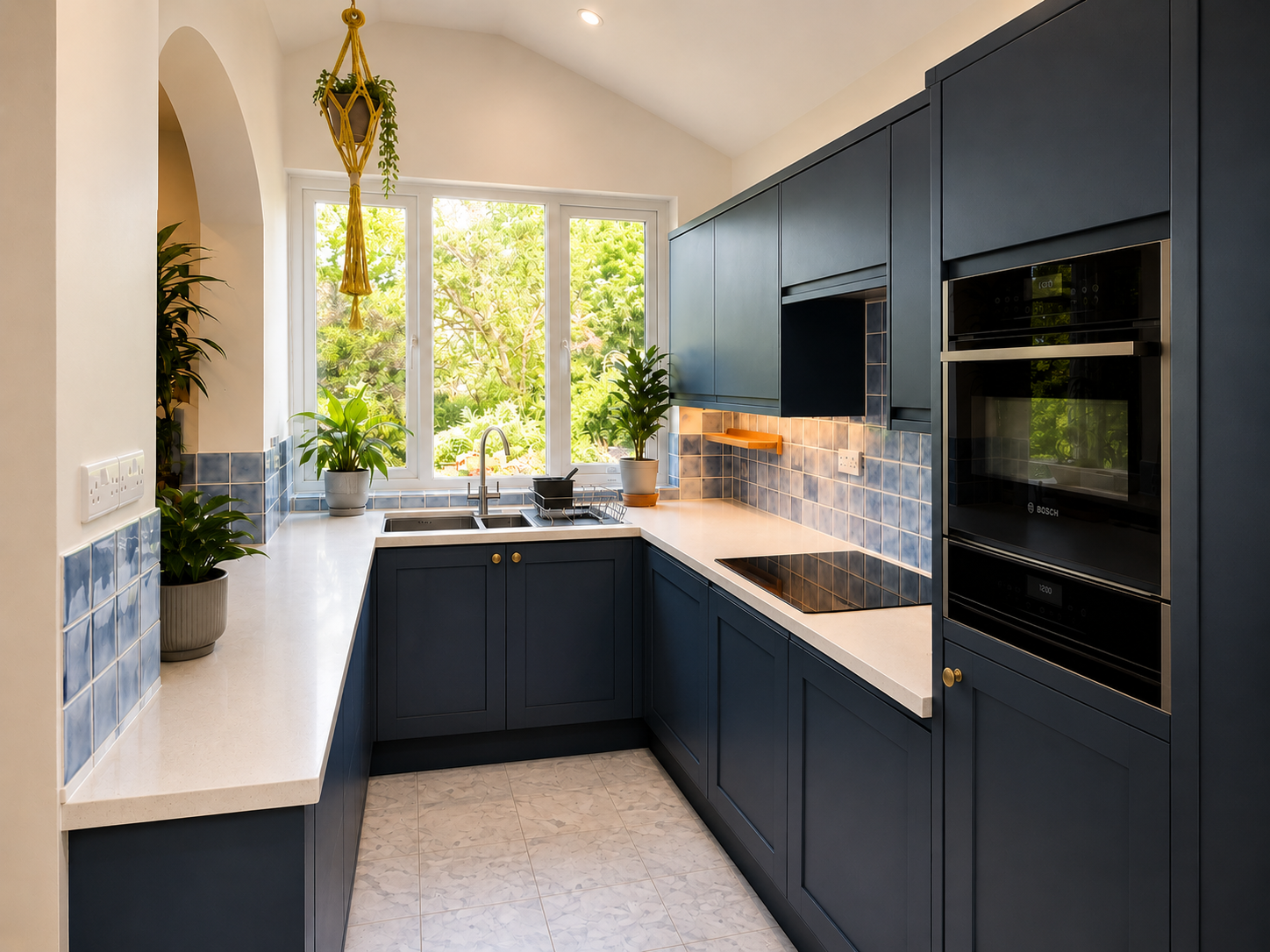 Navy shaker galley kitchen with blue tiled splashback