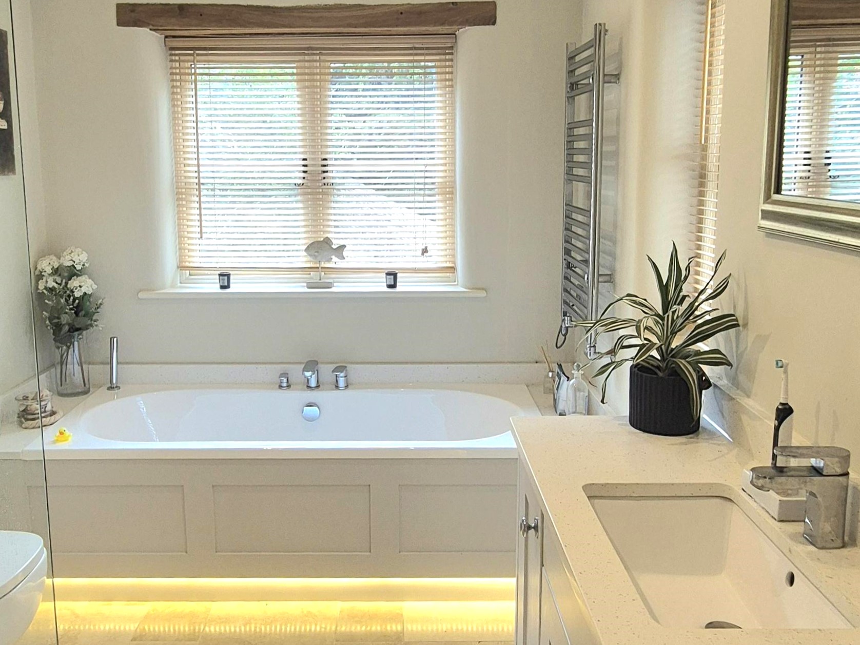 White bathroom with warm under-glow lighting