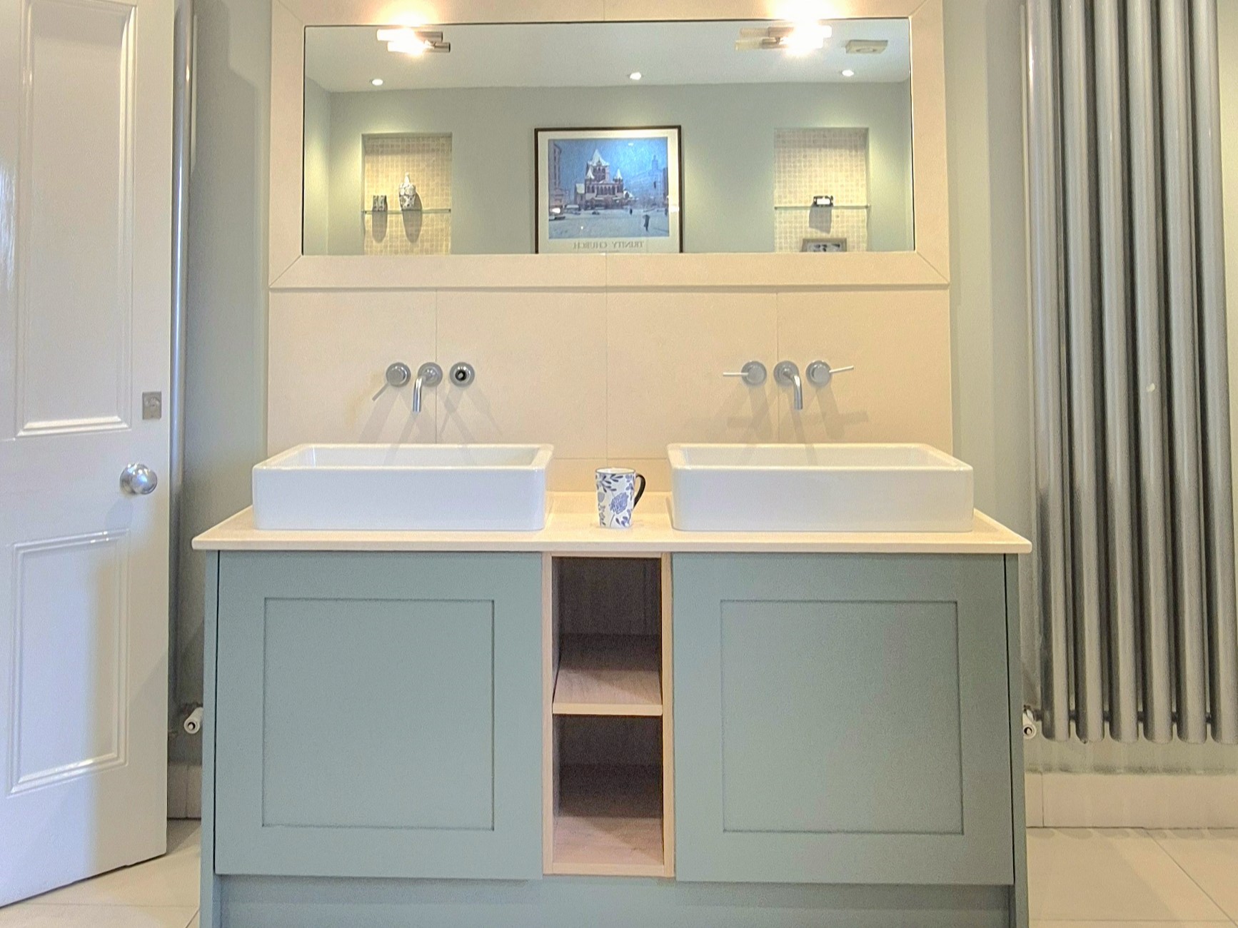 Double vanity with sage cabinetry and vessel basins